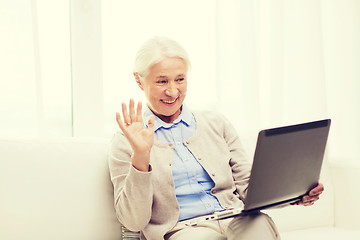 Image showing senior woman with laptop having video chat at home