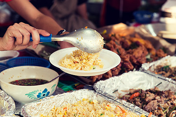 Image showing close up of hands with wok at street market