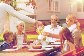 Image showing happy family having holiday dinner outdoors