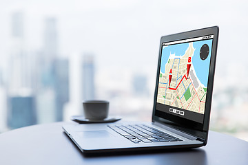 Image showing close up of laptop and coffee cup on office table