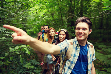 Image showing group of smiling friends with backpacks hiking