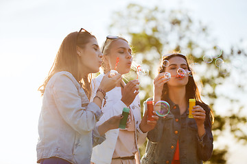 Image showing young women or girls blowing bubbles outdoors