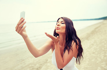 Image showing young woman taking selfie with smartphone