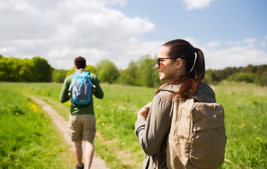 Image showing happy couple with backpacks hiking outdoors