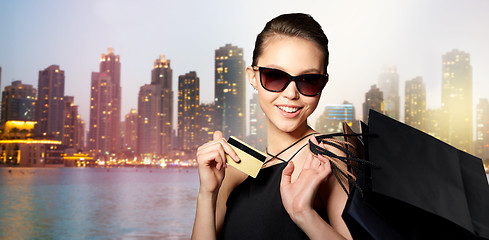 Image showing happy woman with credit card and shopping bags