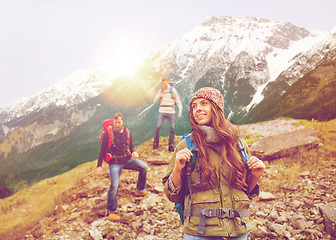 Image showing group of smiling friends with backpacks hiking