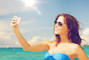 Image showing woman in bikini with phone