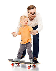 Image showing happy father and little son on skateboard