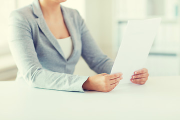 Image showing close up of woman reading papers or tax report