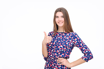 Image showing Happy smiling beautiful young brunette woman showing thumbs up gesture