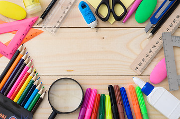 Image showing School stationery on wooden board