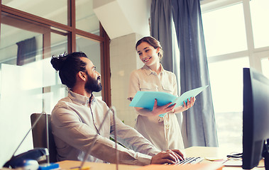 Image showing happy creative team with computer in office