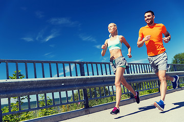 Image showing smiling couple running at summer seaside