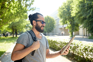 Image showing man traveling with backpack and tablet pc in city