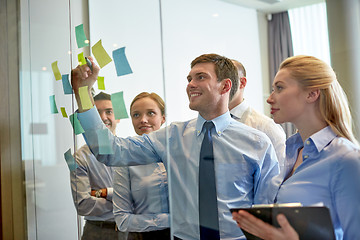 Image showing smiling business people with marker and stickers