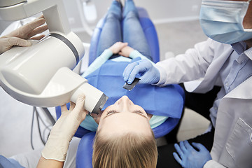 Image showing dentist and patient with dental x-ray machine