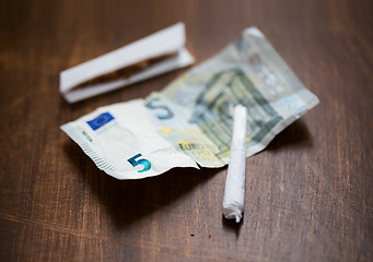 Image showing close up of marijuana joint and money