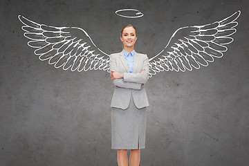 Image showing happy businesswoman with angel wings and nimbus