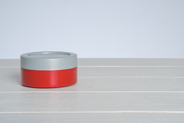 Image showing tib of face cream with red cover