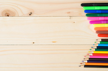 Image showing Colored pencils on a wooden board