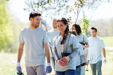 Image showing group of volunteers with trees and rake in park