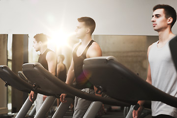 Image showing group of men exercising on treadmill in gym