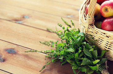 Image showing close up of melissa and basket with apples