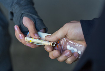 Image showing close up of addict buying dose from drug dealer