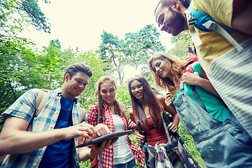 Image showing happy friends with backpacks and tablet pc hiking