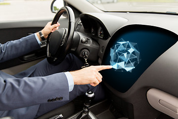 Image showing man driving car and pointing to on-board computer