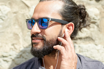 Image showing man with earphones listening to music outdoors