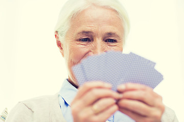 Image showing close up of happy senior woman playing cards