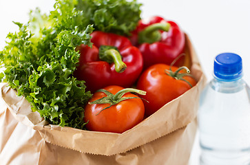 Image showing close up of paper bag with vegetables and water