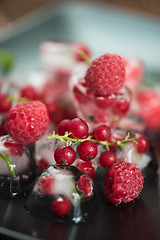 Image showing Frozen berries on wooden table