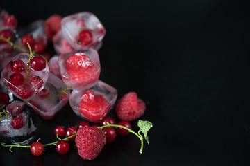Image showing Frozen berries on wooden table