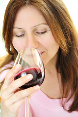 Image showing Mature woman with a glass of red wine