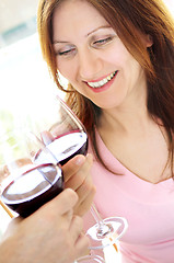 Image showing Mature woman toasting with red wine