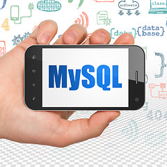 Image showing Database concept: Hand Holding Smartphone with MySQL on display