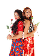 Image showing Two beautiful woman holding a rose.