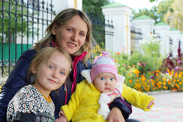 Image showing happy mother sitting with her little daughters 