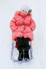 Image showing pretty girl sitting on the sledge
