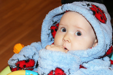 Image showing little baby in dressing gown with amazed sight