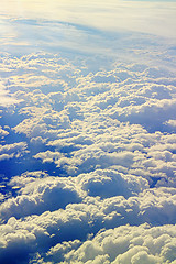 Image showing Clouds pass under wing of plane