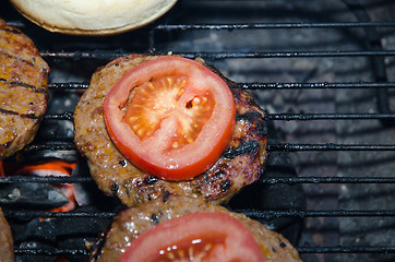 Image showing Barbequing hamburgers