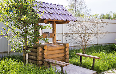 Image showing Wooden well with buckets for water.