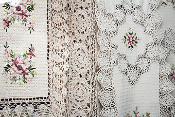 Image showing Tablecloths and napkins, decorated with embroidery and lace.