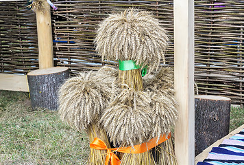 Image showing A few sheaves of wheat decorated with ribbons..