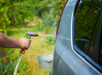 Image showing People cleaning car using high pressure water