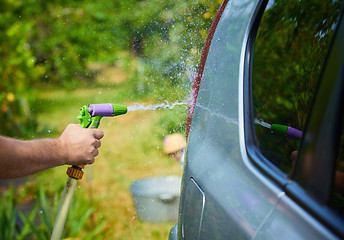 Image showing People cleaning car using high pressure water