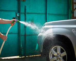 Image showing People cleaning car using high pressure water